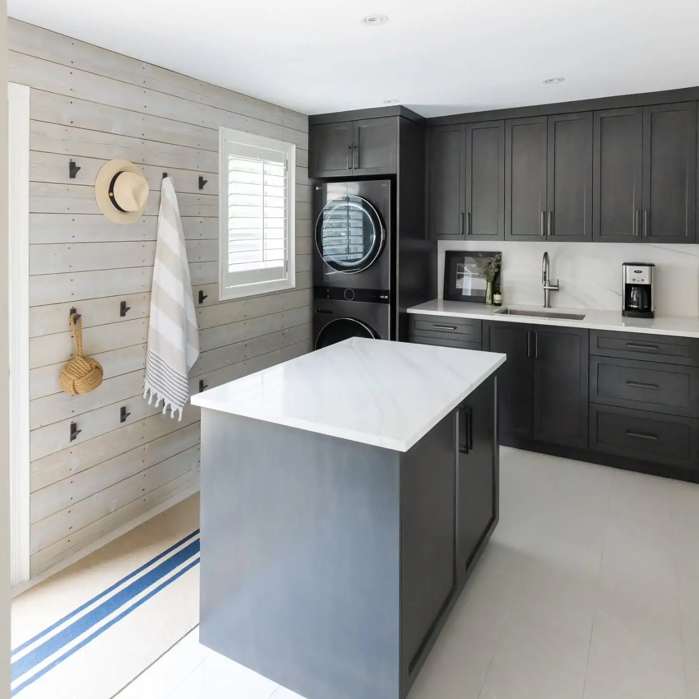 Stained maple laundry cabinetry by Heirlooms Custom Cabinetry