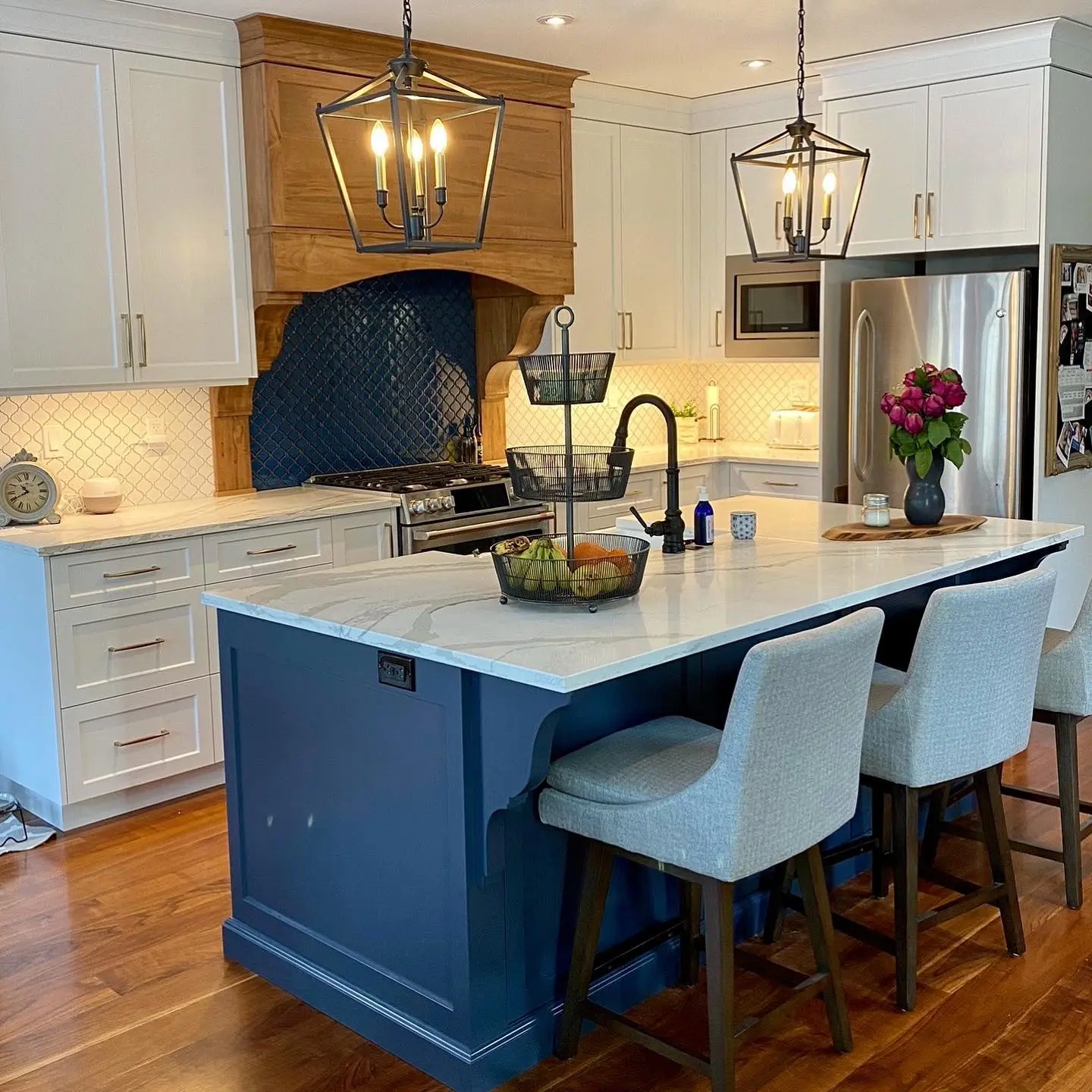 Maple kitchen with island and backsplash cabinetry by Heirlooms Custom Cabinetry