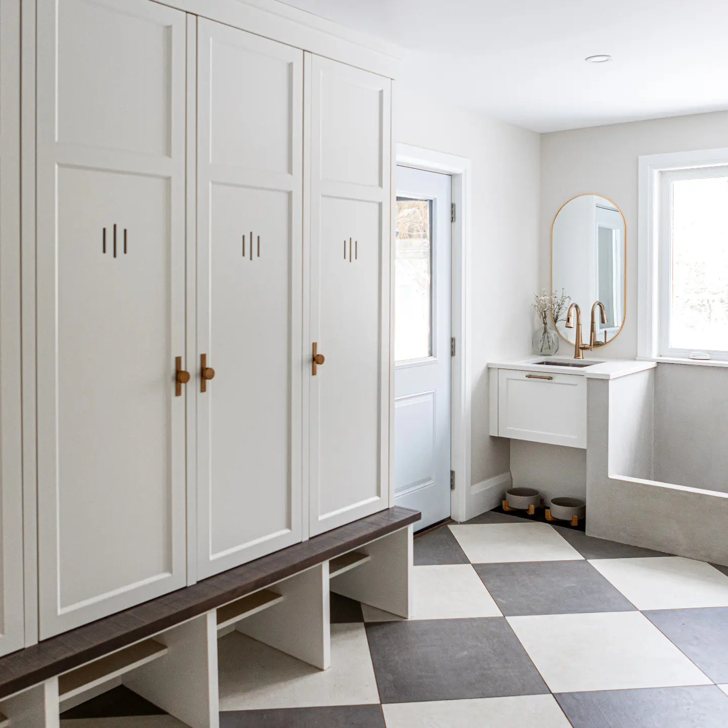 Mudroom with storage and vented cabinetry by Heirlooms Custom Cabinetry